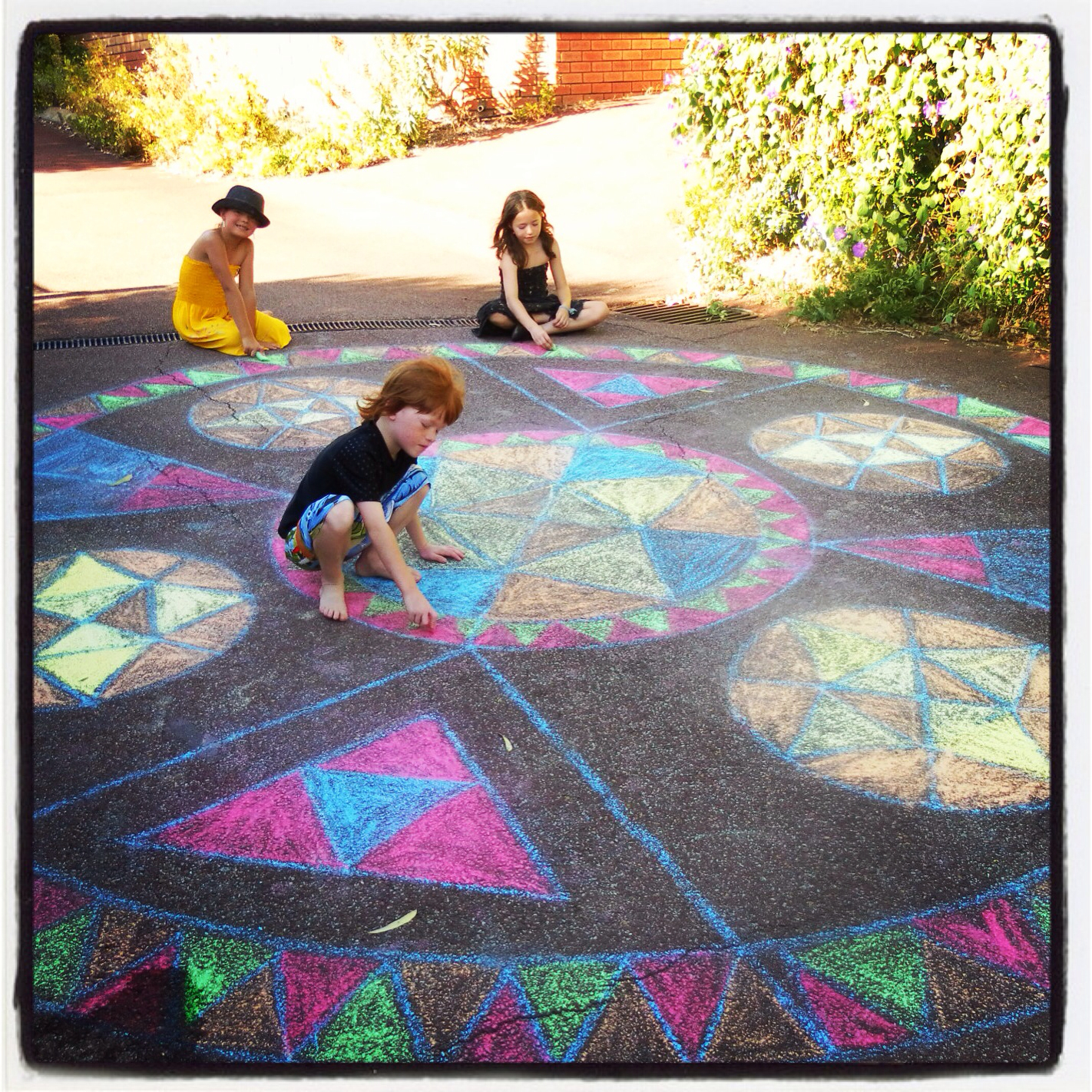 The kids colouring a huge Rainbow Mandala
